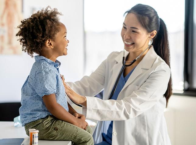 Smiling doctor attending a child - link to The General Labs Health Insurance page